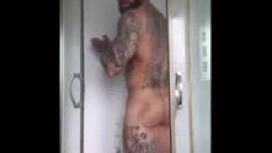 Bearded tattooed stud showering
