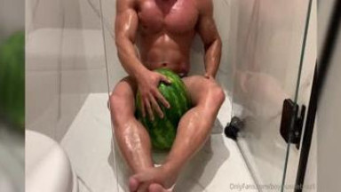 muscle posing with watermelon