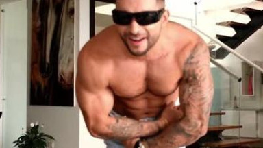 Handsome model posing and jerking for a webcam show