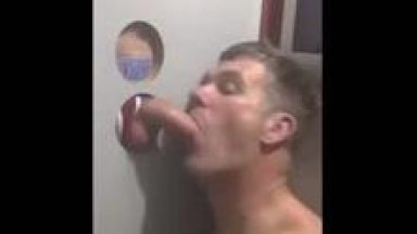 Sucking dicks at a gloryhole