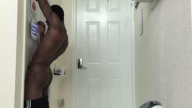 hot black guy gets a blowjob in a gloryhole