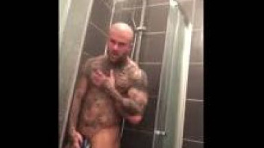 Tattooed man in shower